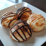 Cloud Bread Bites – Fluffy, golden bite-sized bread pieces stacked on a plate, airy and perfect for keto snacking.