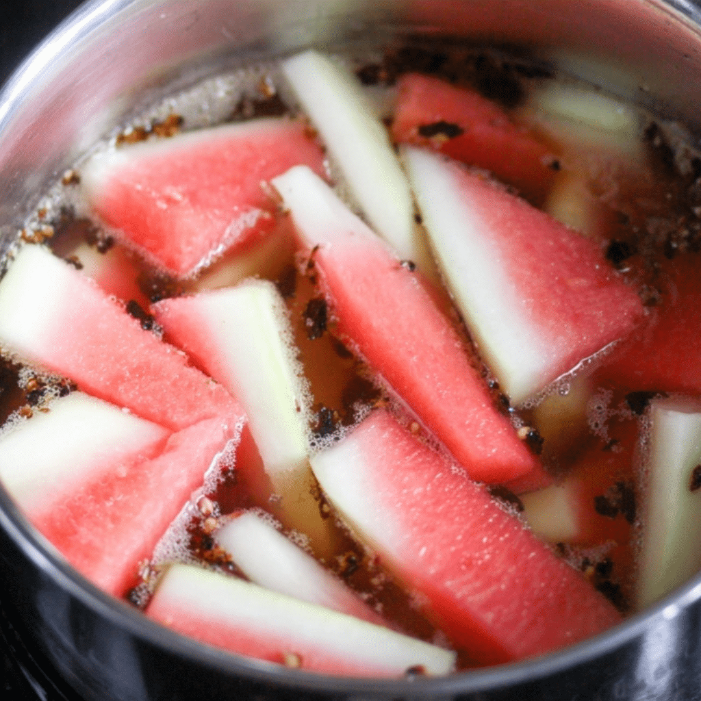 Watermelon Pickle Rind Recipe – A mason jar filled with sweet and tangy pickled watermelon rinds, seasoned with mustard seeds and spices.